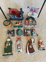 Group shot of all 15 hand-painted wooden Christmas decor items