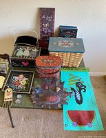 Overview of all hand-painted wood and metal decor items displayed on table