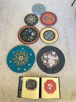 Seven trays in assorted colours and book opened to colour plates