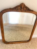 Full view of wood framed mirror showing overall shape and glass