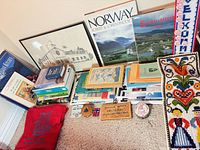 Full lot view with books, framed print, pouch, plaque, tin