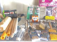 Overall view of shelf with brushes, drop cloths, roller covers, pad refill