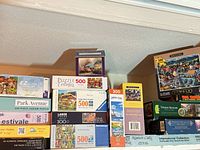 Wide shot of shelf showing most puzzle boxes