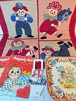 Overall lot showing quilt, books, tray, cardboard piece