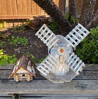 Windmill and birdhouse on bench, full view