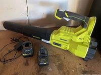 Blower with nozzle attached, battery inserted, charger and power cord