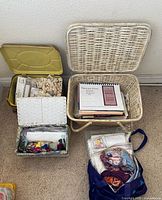 Overall view of three containers: yellow-lid organizer, white wicker sewing box, wicker basket with patterns and blue tote