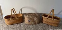 Group shot of two Nantucket-style baskets and seagrass lidded basket