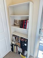 Full view of bookshelf with shelves and contents for scale
