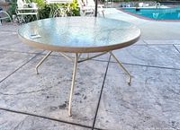 Full view of round patio table on concrete deck
