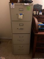 HON beige four-drawer filing cabinet front view