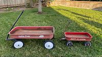 Large and small Radio Flyer wagons side by side on grass