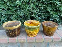 Three planters side by side showing size, color, patterns