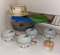 Group view of all ceramic items on shelf