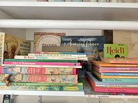 Shelf with horizontal and vertical stacks of vintage children’s books
