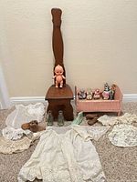 Full lot showing chair, crib, doll, figurines, clothing, bottles, shoes, bird