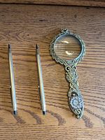 Pen, pencil, and magnifier grouped