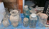 Overall lot showing jars and vases on blue surface