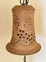 Close-up of ceramic lamp unlit showing perforations and texture