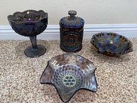 All four carnival glass pieces side by side