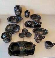 group shot of all 18 moriage redware pieces