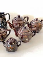 Group view showing pitchers, teapots and creamer