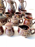 Close-up of small pitchers, sugar bowls, shakers