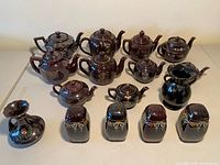 Group shot showing teapots, shakers, vases, creamer