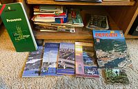 Overall lot showing brochures and postcards on floor and shelf