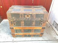 Closed trunk showing exterior wood slats, canvas panels, hardware, missing lock