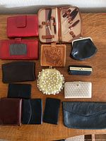 Group shot of all twelve wallets and coin purses laid on table