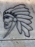 Full view of metal wall art on concrete background