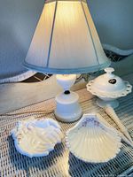 Group view: lamp illuminated, covered dish, two smaller dishes, hobnail handled piece