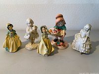 Group shot of all five porcelain figurines