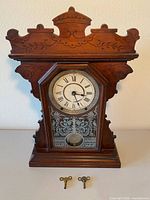 Front view of clock showing full case and keys