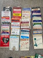 Four vertical stacks of vintage sheet music laid out on carpet
