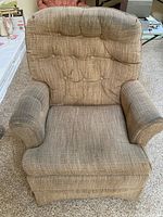 Front view of upholstered swivel rocker chair showing overall style and wear
