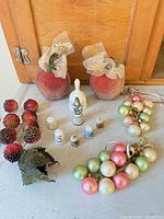 Full lot showing thimbles, bell, faux apples, grape and berry ornaments