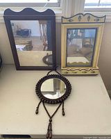 Overview of all three wall mirrors on table