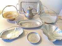 Group view of all seven serveware items and teapot