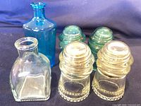 Group shot of four insulators and two bottles