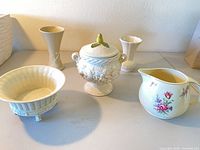 Group shot showing all five ceramic pieces: planter, tall vase, tureen, small vase, floral pitcher