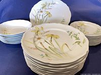 Stacked dinner plates, bowls, salad plates and serving platter showing floral design