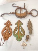 All six metal pieces including scale, two bill holders, two finials, wall hook