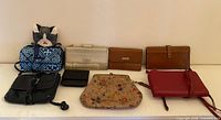 Group shot of all wallets and crossbody bags on shelf