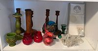 Shelf view showing all wood candlesticks, glass holders, boxed Decora item and fused glass panel