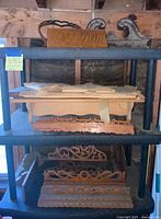 Multiple wood shelf parts stacked on plastic shelving unit