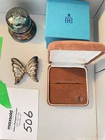 Open Birks ring box with outer sleeve and butterfly brooch