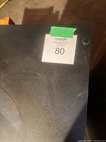 Top surface showing matte black finish and lot sticker