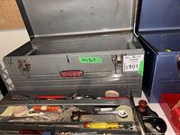 Open silver Craftsman toolbox with tool tray; blue and red toolboxes partially visible